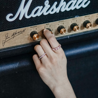 Hand with moonstone ring adjusting amp volume.