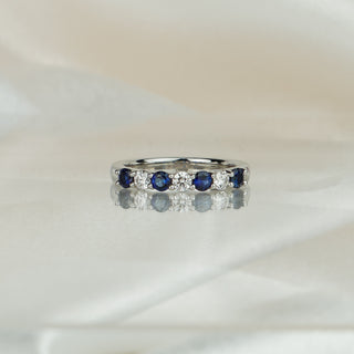 Platinum band with four natural Ceylon blue Sapphires alternating three Diamonds, 3.1mm stone row across the front.