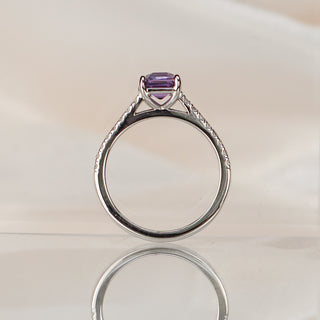 Asscher cut purple Sapphire engagement ring standing upright with reflection, cathedral gallery visible beneath the stone.