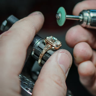 Fine jewelry production in progress, setting work under way at the workbench.