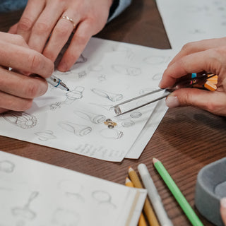 Close view of a hand-drawn fine jewelry design sketch with ring proportions.