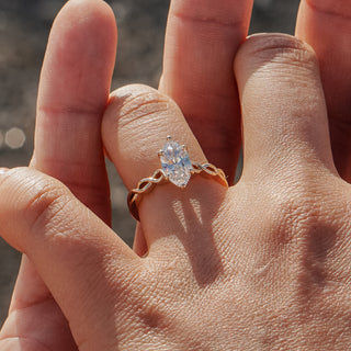 Marquise engagement ring worn on the hand at the beach in Vancouver.