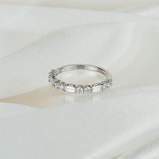 Lab grown diamond alternating baguette and round brilliant wedding band in white gold on satin fabric, shared prong set stones across the front.