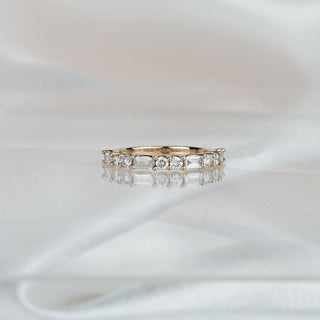 Yellow gold band with round brilliants alternating baguette lab grown diamonds, 2.6mm stone row in shared prongs.