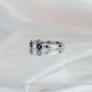 Side view of a Ceylon blue Sapphire and Diamond wedding band in white gold, 3.8mm stones tapering to a 2.6mm band.