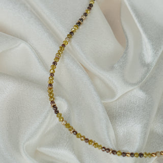 Necklace with small beads on a white fabric background