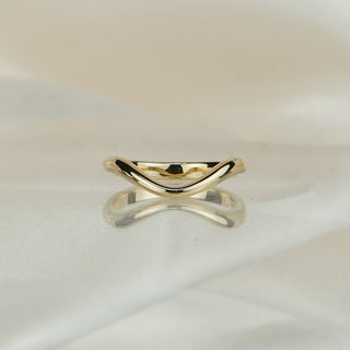 Two yellow gold shadow bands crossed on ivory satin, showing the curved profile from both sides.