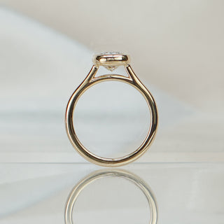 Cushion bezel cathedral ring standing upright with reflection, arched shoulders rising to the enclosed stone.