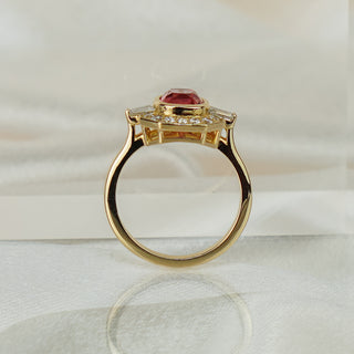 Cushion pink Spinel art deco style engagement ring standing upright with reflection, frame structure across the top.
