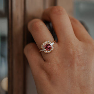 Natural pink Spinel engagement ring worn on the hand, cushion center inside a Diamond set milgrain frame.