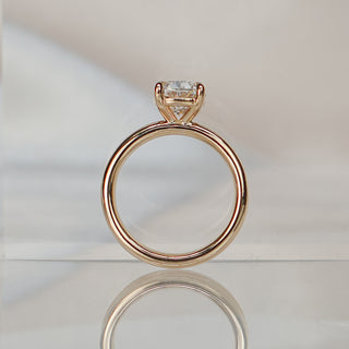 Cushion cut lab diamond double shank ring standing upright with reflection, four prongs above the paired bands.