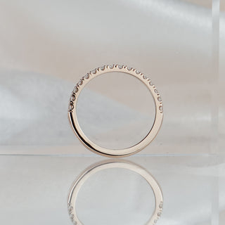 Micro pavé natural Diamond wedding band standing upright with reflection, slim rose gold circle in frame.