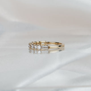 Side view of an alternating cut lab diamond band in yellow gold, stones tapering to a slim 1.8mm back.
