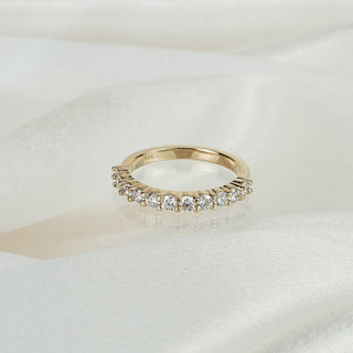 Lab grown diamond half eternity wedding band in 14k yellow gold on satin fabric, eleven round brilliants in shared claws.