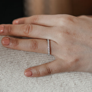 Micro pavé lab diamond band worn on the hand, fine 1.9mm white gold profile with stones catching light.