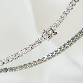 Close view of the box clasp on a white gold lab grown diamond tennis bracelet, prong set stones on either side.