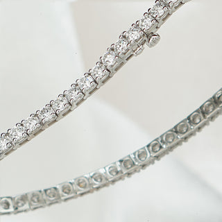 Round brilliant lab grown diamonds in white gold tennis bracelet links, two strands running parallel in close view.