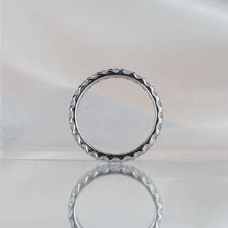 Full eternity lab diamond band standing upright with reflection, 2.4mm round brilliants circling the entire band.