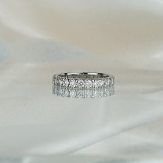 White gold full eternity band with scallop shared prong set lab grown diamonds, stones continuing past the shoulder with no plain back.