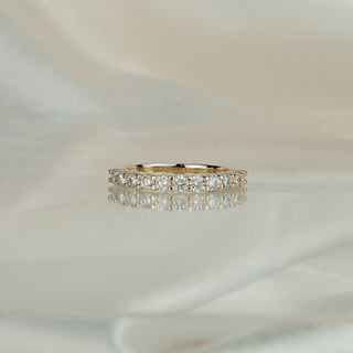 Side view of a lab grown diamond half eternity band in yellow gold, 2.5mm band tapering to a plain back.