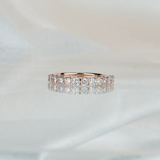 Rose gold band with shared prong set lab diamonds, 2.3mm stones in a row along the front.