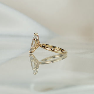 Side view of a marquise flower head engagement ring, sculptural prong detail visible above the plain 2.0mm band.