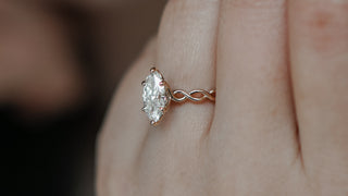 Marquise engagement ring worn on the hand.