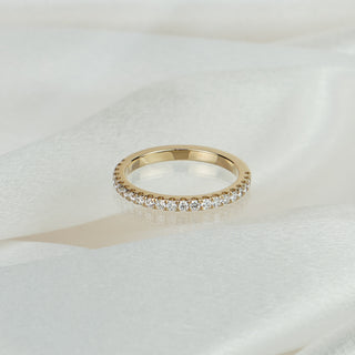 Lab grown diamond micro pavé half eternity band in yellow gold on satin fabric, twenty-two small round brilliants across the front.