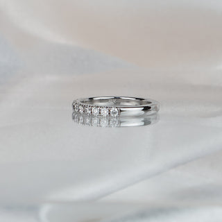 Side view of a lab diamond micro pavé half eternity band in white gold, stone row meeting a plain polished back.
