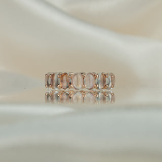 Rose gold full eternity ring with oval natural Moonstones in shared claws, continuous stone row across the band.