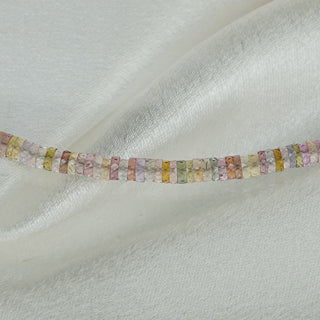 Close view of natural Sapphire tire beads showing shade variation from stone to stone along the strand.