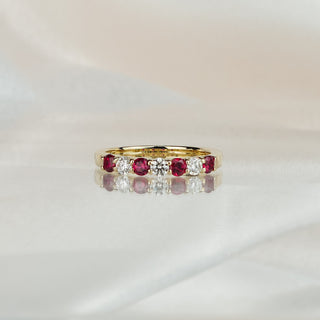 Yellow gold band with four natural Burmese Rubies and three Diamonds in shared claws, stone row across the front.