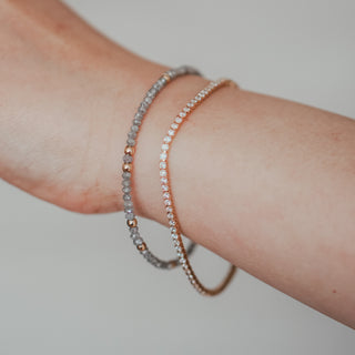 Yellow gold natural Diamond tennis bracelet on the wrist, worn view showing the stone line following the wrist's curve.