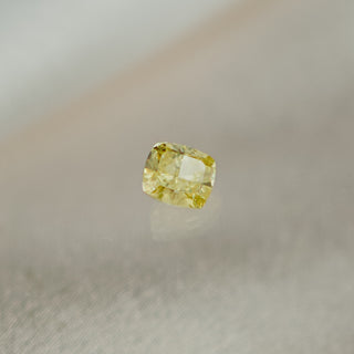 Yellow diamond on a gray background