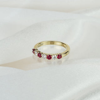 Natural Burmese Ruby and Diamond wedding band in yellow gold on satin fabric, four rubies alternating with three round brilliants in shared claws.