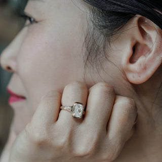 Old mine cushion solitaire worn on the hand, antique style faceting in a yellow gold bezel.