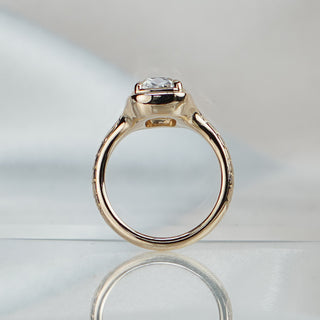 Old mine cushion cut lab diamond ring standing upright with reflection, 4.5mm engraved band tapering behind the stone.
