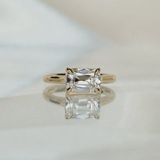 Yellow gold solitaire with a 2.04 carat old mine cut lab diamond set horizontally, prongs at the corners of the stone.