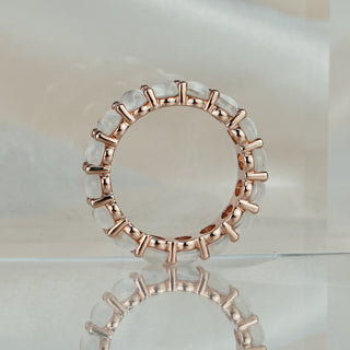 Full circle view of a natural Moonstone eternity ring in rose gold, shared claws visible between each oval stone.