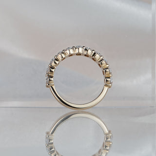 Oval cut half eternity style band standing upright with reflection, shared prongs holding the row of ovals.