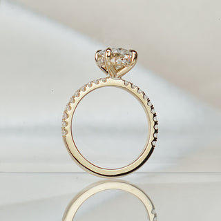 Oval lab diamond hidden halo ring standing upright with reflection, beaded pavé shank rising to the four-prong center.