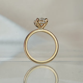 Oval lab diamond hidden halo solitaire standing upright with reflection, unadorned band rising to the concealed halo.