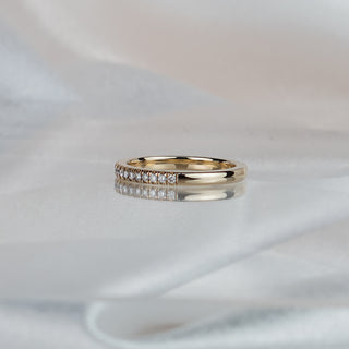 Side view of a natural Diamond micro pavé band in yellow gold, 1.3mm stones meeting a plain polished back.