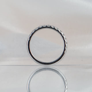 Micro pavé half eternity band standing upright with reflection, fifteen round brilliants bead set in white gold.