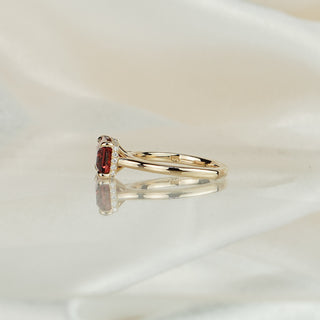 Side view of a pink Tourmaline hidden halo ring, concealed round brilliants visible under the east-west set center.