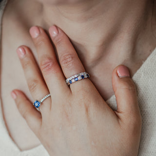 Natural blue Sapphire and Diamond band worn on the hand in platinum, stacked pairing at the chest.