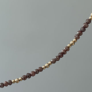 Video of a natural brown raw faceted Diamond bracelet in close view, unpolished facets and gold beads in motion.