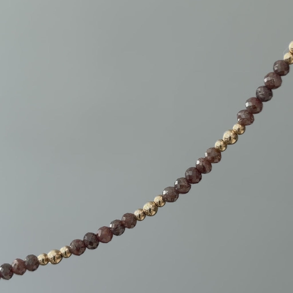 Video of a natural brown raw faceted Diamond bracelet in close view, unpolished facets and gold beads in motion.