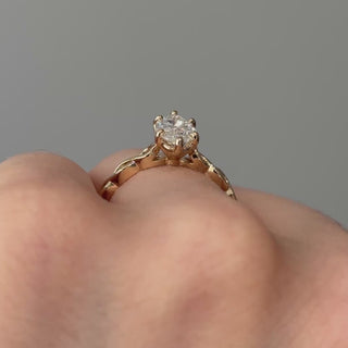 Video of a yellow gold marquise lab grown diamond solitaire worn on the hand, braided shank turning through the light.