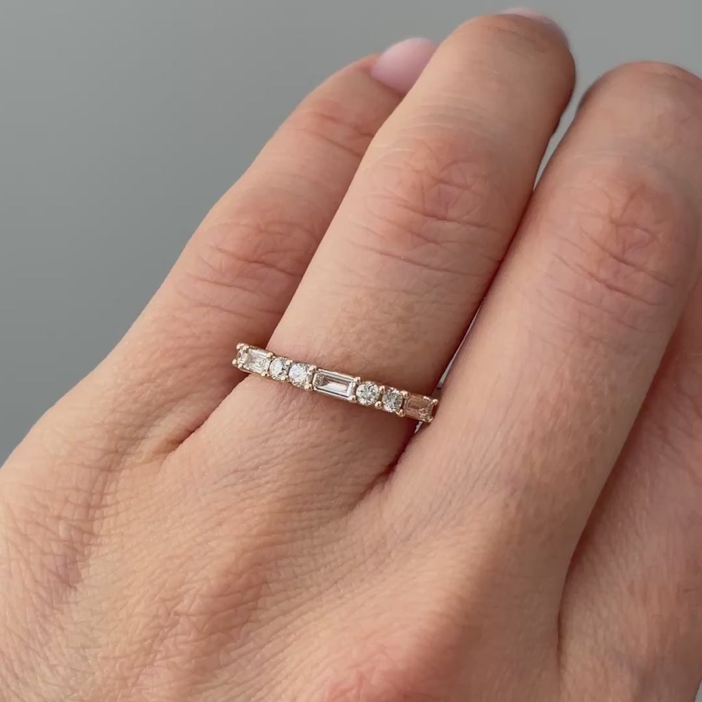 Video of a yellow gold lab grown diamond alternating baguette and round band worn on the hand, two cuts in motion.